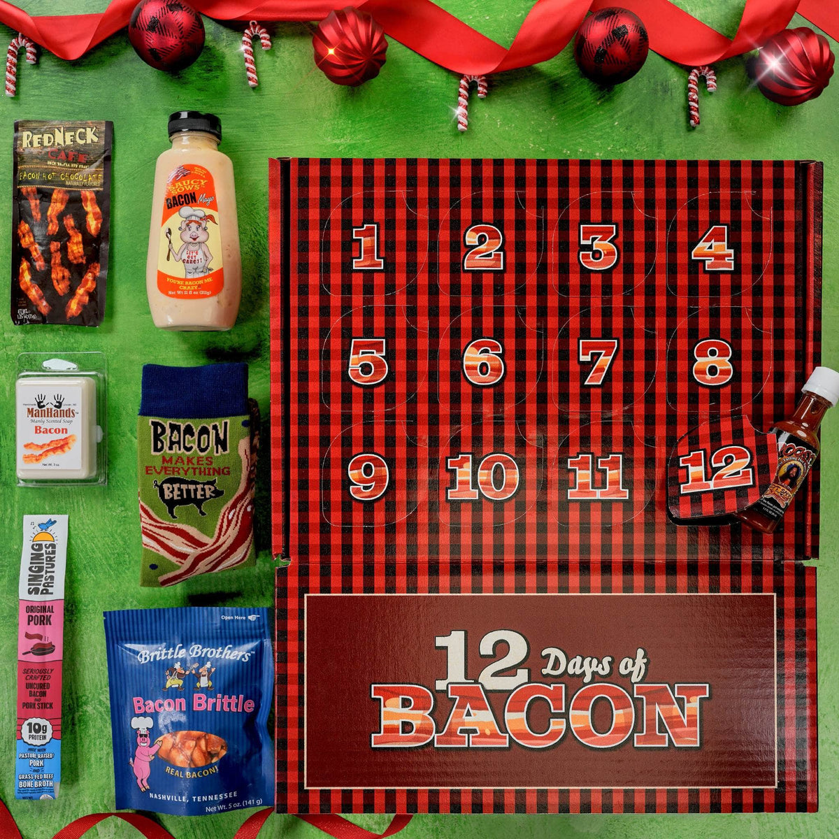 A Christmas-themed bacon advent calendar flat lay on a bright green background. The main product is a red and black buffalo plaid box labeled '12 Days of BACON' with numbered compartments.