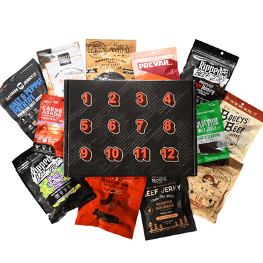A 12-day beef jerky advent box set featuring a black numbered advent calendar box surrounded by 12 different beef jerky snack bags in various colors, arranged on a plain white background.