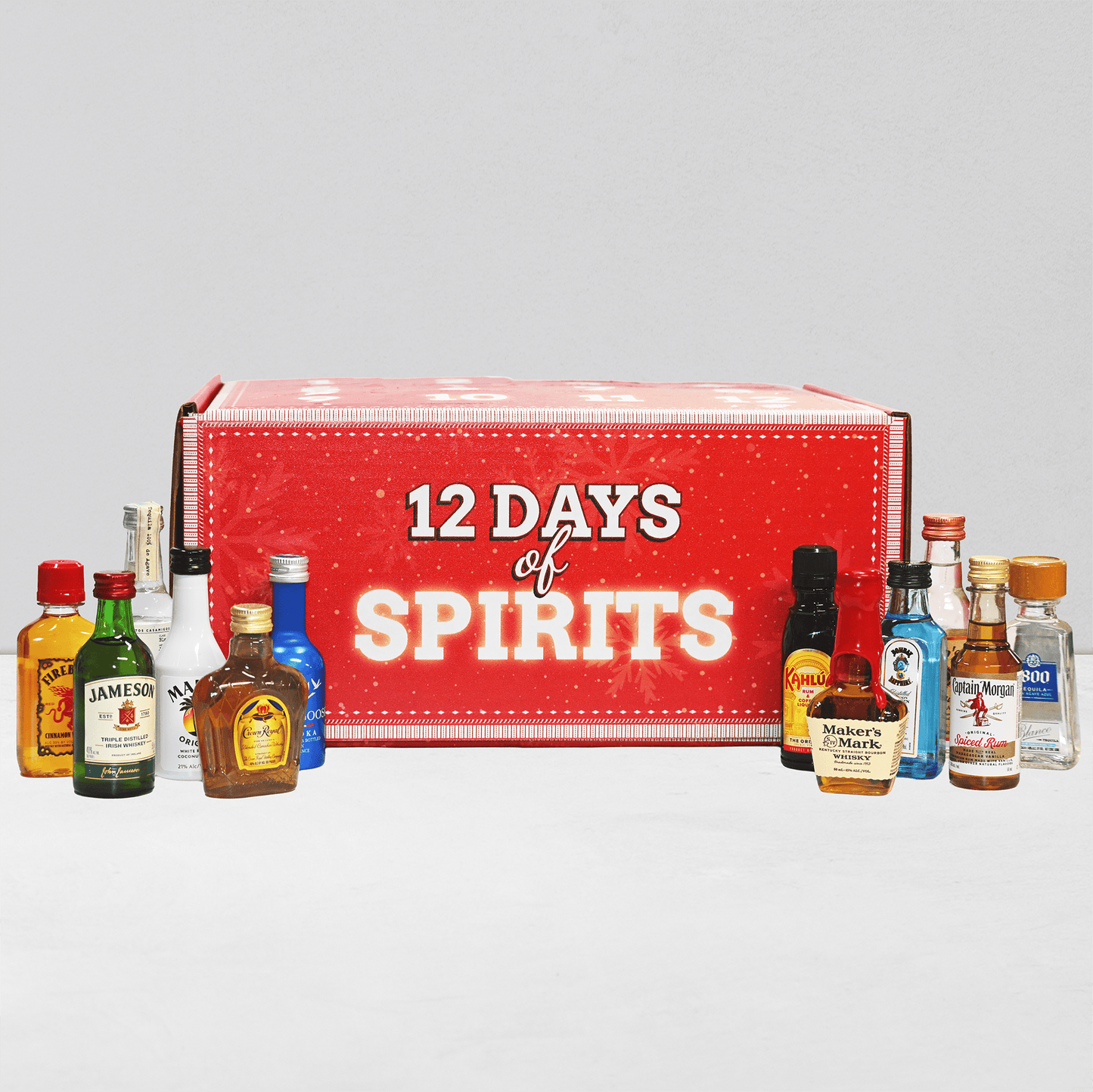 Red box labeled '12 Days of Spirits' with miniature liquor bottles displayed in front on a light gray background.
