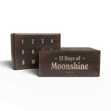 Two rustic dark brown wooden boxes on a white background. The front box is labeled '12 Days of Moonshine' in a distressed cream font, and the back box shows numbered compartments from 1 to 10.