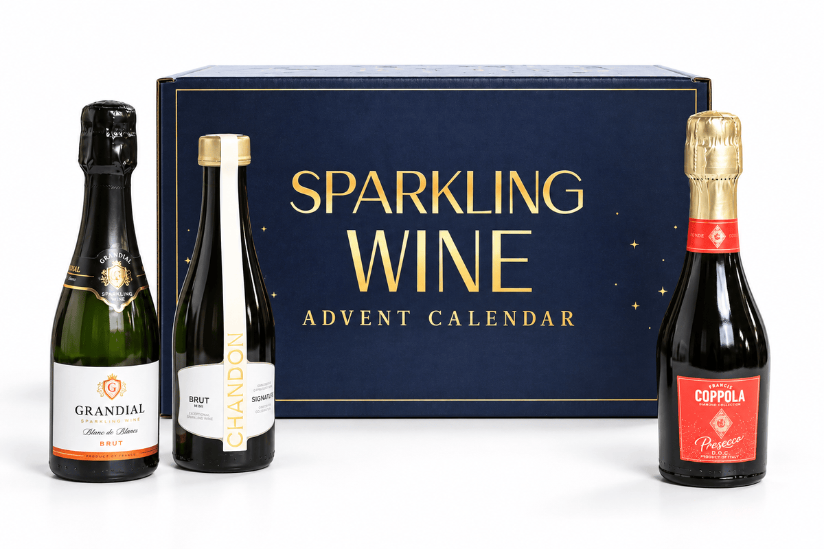 A sparkling wine advent calendar set featuring a dark blue box with gold lettering that reads 'SPARKLING WINE ADVENT CALENDAR,' flanked by three miniature sparkling wine bottles: Grandial, Chandon, and Coppola, on a white background.
