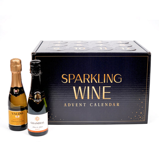 A boxed advent calendar of sparkling wine, featuring a large black box with gold lettering that reads 'SPARKLING WINE ADVENT CALENDAR,' alongside two small sparkling wine bottles in front on a white background.