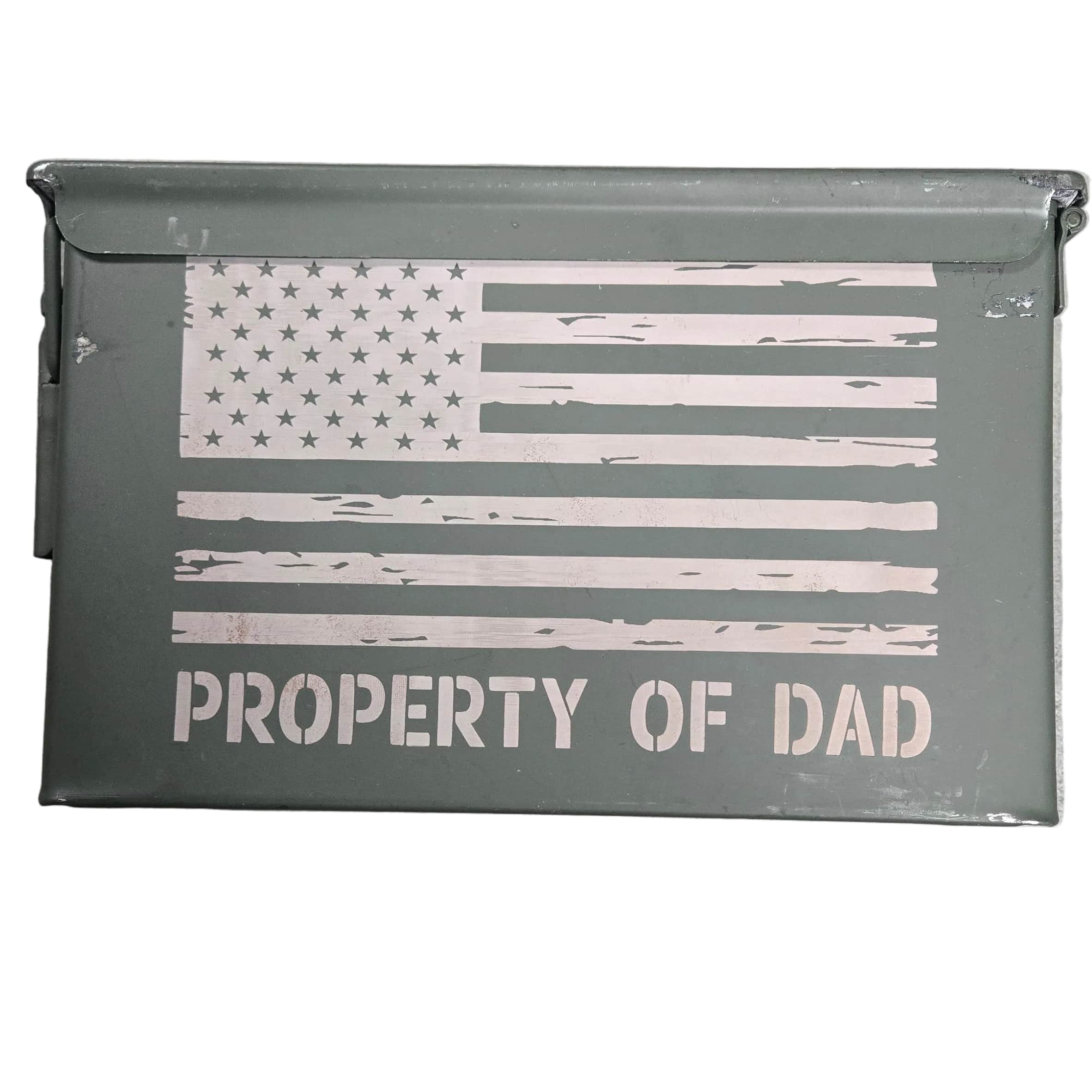 Metal box with American flag design and 'Property of Dad' text on a gray surface