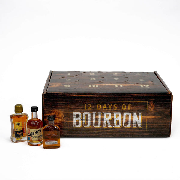 A 12-day bourbon whiskey advent calendar with three small bottles of bourbon whiskey placed in front on a white background.