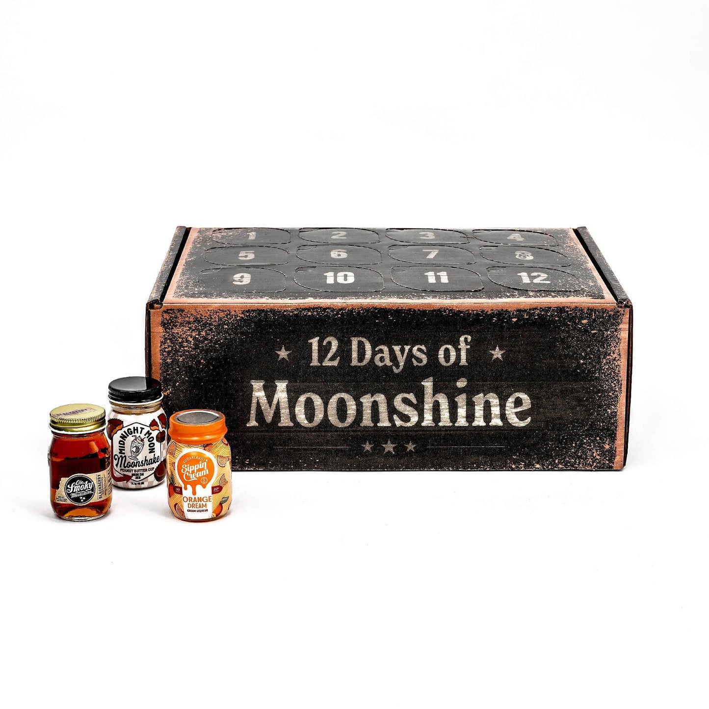 A rustic advent calendar box labeled '12 Days of Moonshine' with three small glass bottles placed in front on a clean white background.